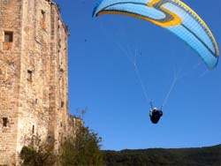 Paraglider flying past a chateau in France